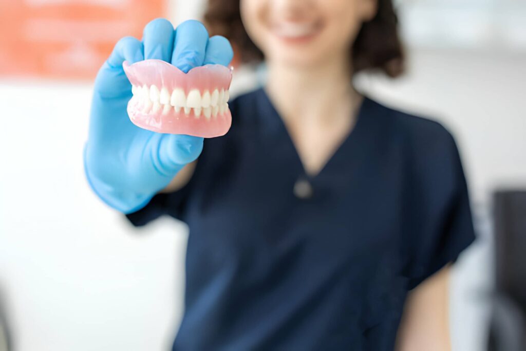 How often should I get my dentures adjusted?